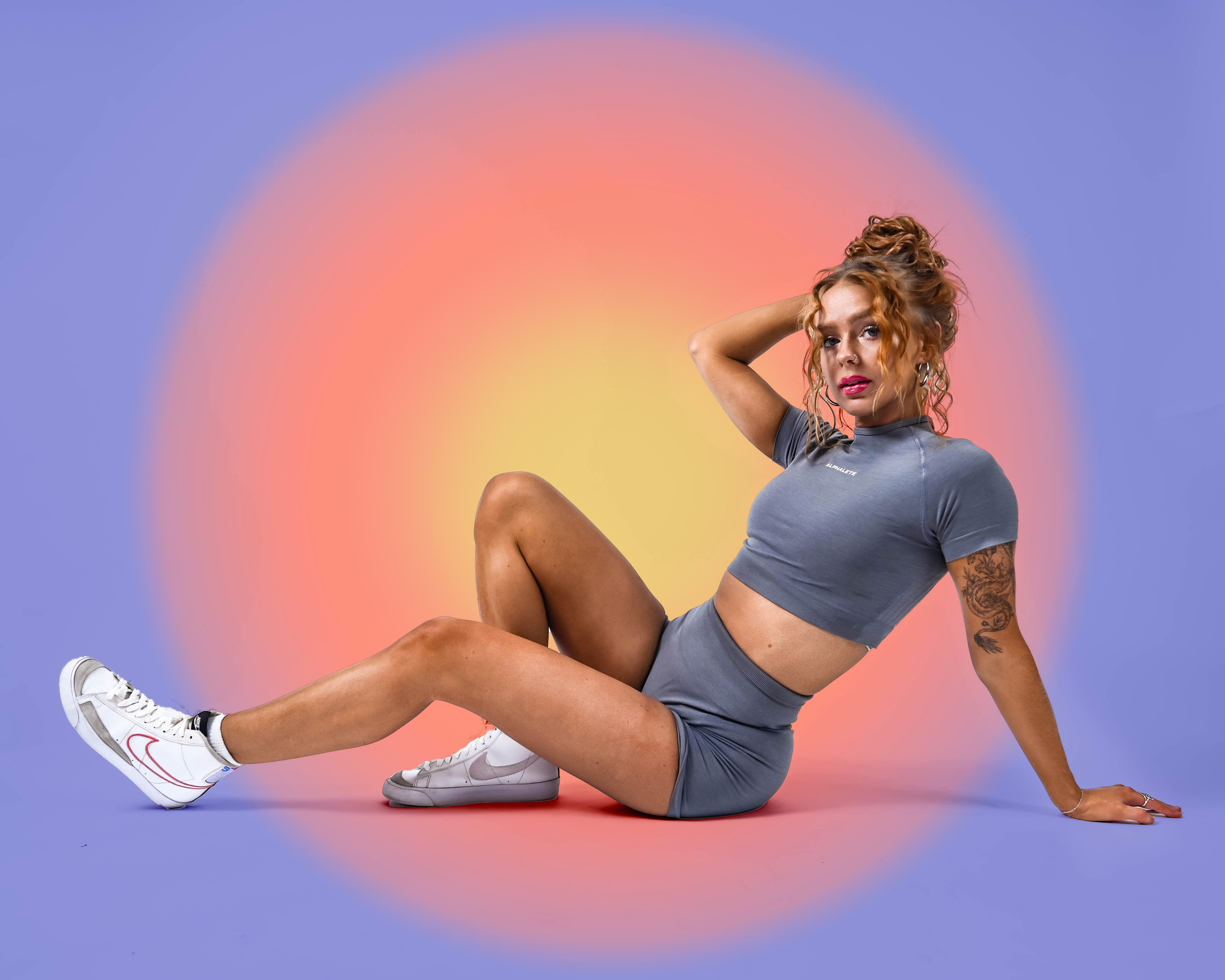Coach is laying down posing in a studio